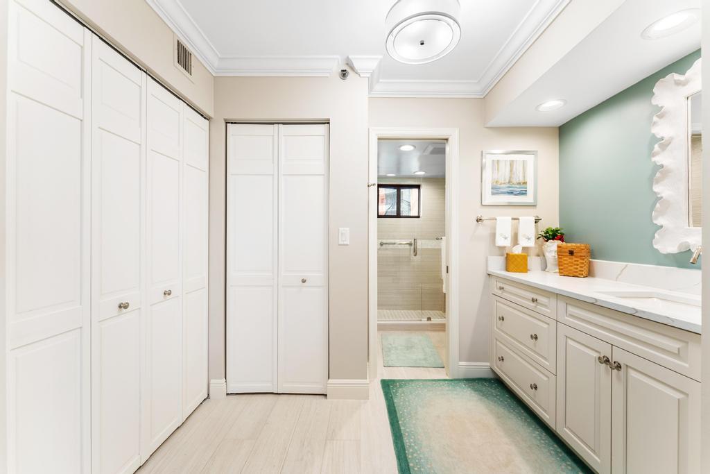 200 Ocean Trail Way, Unit T7 Jupiter, FL 33477 - Photo 22 of 46 a spacious bathroom with a double vanity sink a mirror and a shower