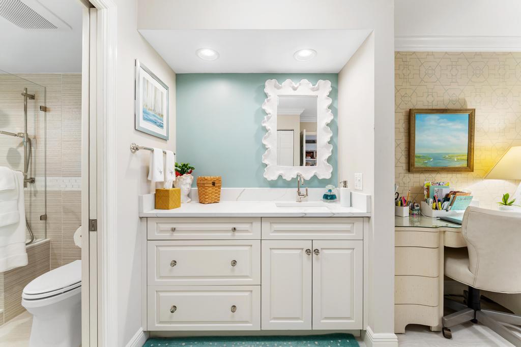 200 Ocean Trail Way, Unit T7 Jupiter, FL 33477 - Photo 23 of 46 a bathroom with a sink a toilet and a large mirror