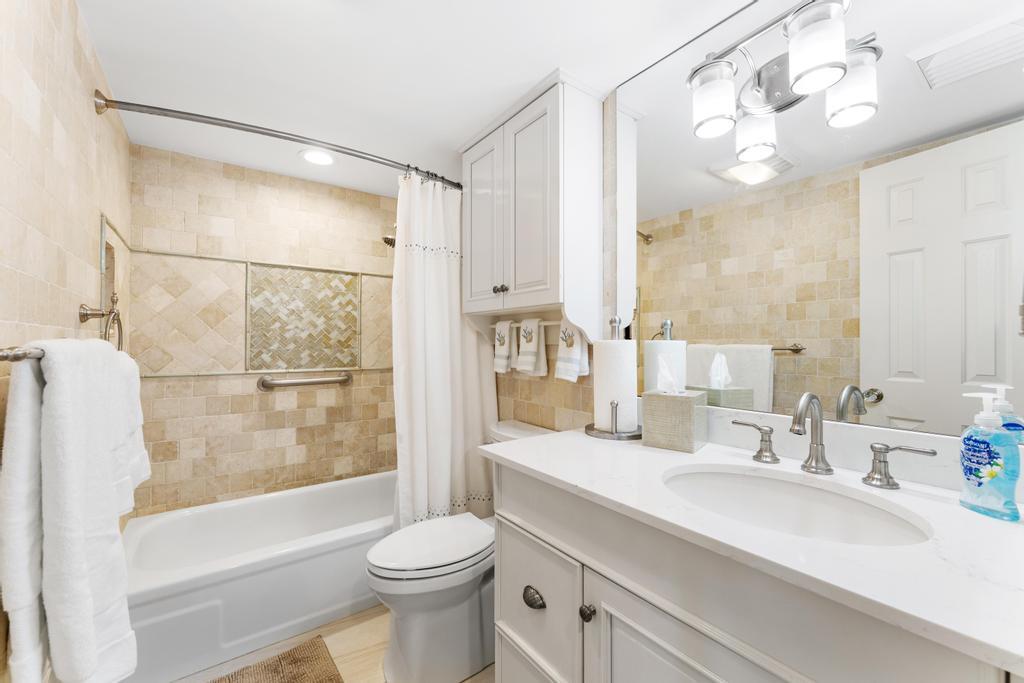 200 Ocean Trail Way, Unit T7 Jupiter, FL 33477 - Photo 29 of 46 a bathroom with a sink a toilet and a large mirror