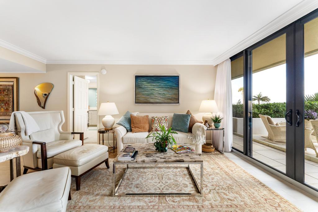 200 Ocean Trail Way, Unit T7 Jupiter, FL 33477 - Photo 5 of 46 a living room with furniture and a floor to ceiling window
