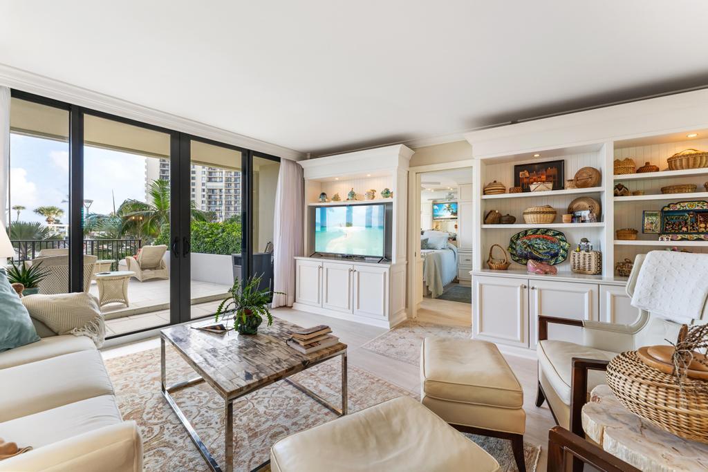 200 Ocean Trail Way, Unit T7 Jupiter, FL 33477 - Photo 8 of 46 a living room with furniture and a floor to ceiling window