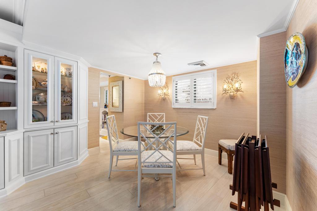 200 Ocean Trail Way, Unit T7 Jupiter, FL 33477 - Photo 10 of 46 a view of a dining room with furniture and a window