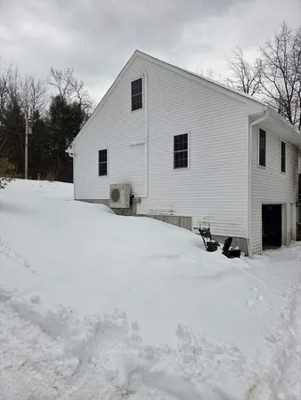 a view of a house with a yard covered in snow