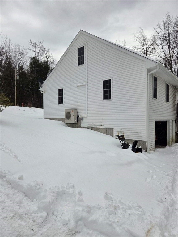 1578 Greenville Road Ashby, MA 01431 - Photo 1 of 17 a view of a house with a yard covered in snow