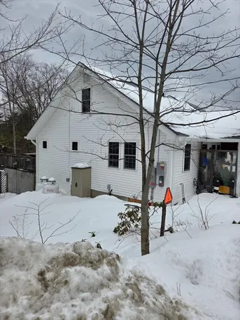 a view of a house with a snow in the yard