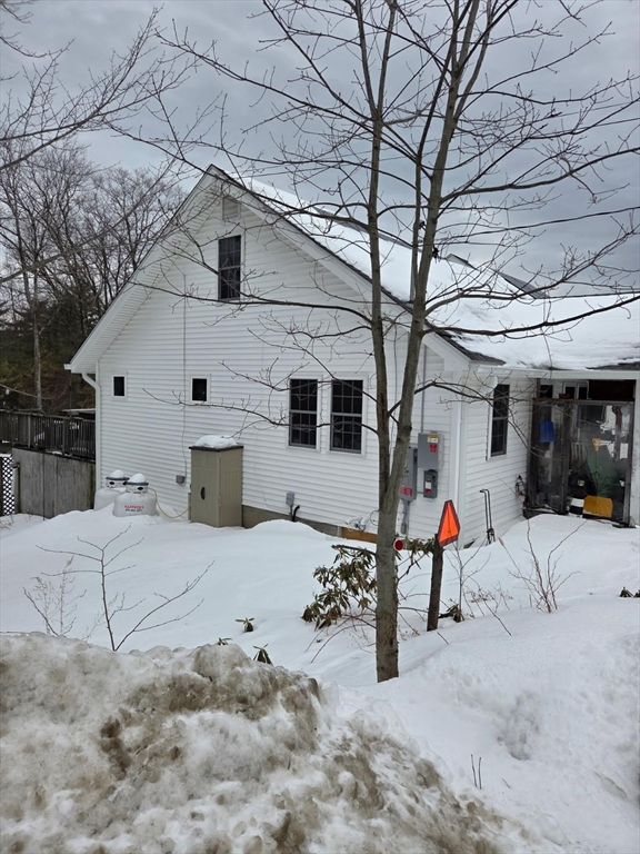 1578 Greenville Road Ashby, MA 01431 - Photo 4 of 17 a view of a house with a snow in the yard