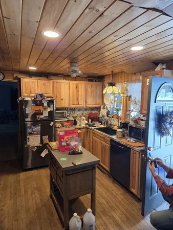 a kitchen with stainless steel appliances granite countertop a stove sink and cabinets