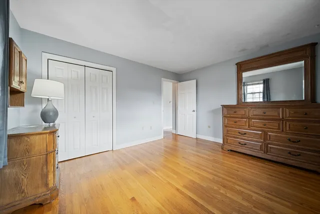 a view of room with wooden floor and cabinet