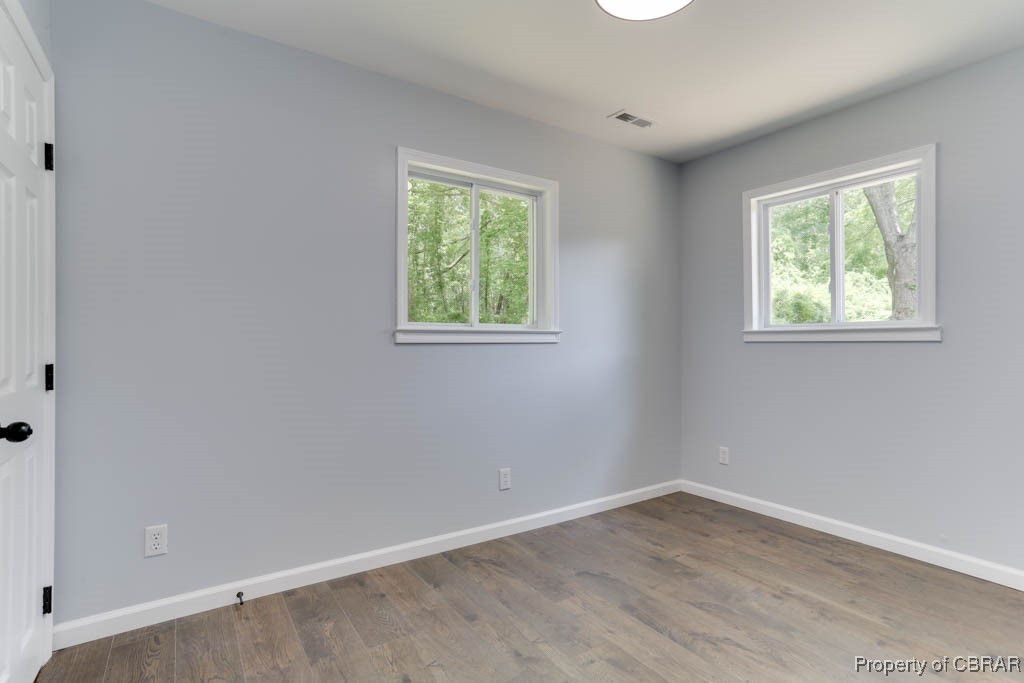 917 Chapel Neck Road North, VA 23128 - Photo 18 of 29 Empty room featuring baseboards and wood finished floors
