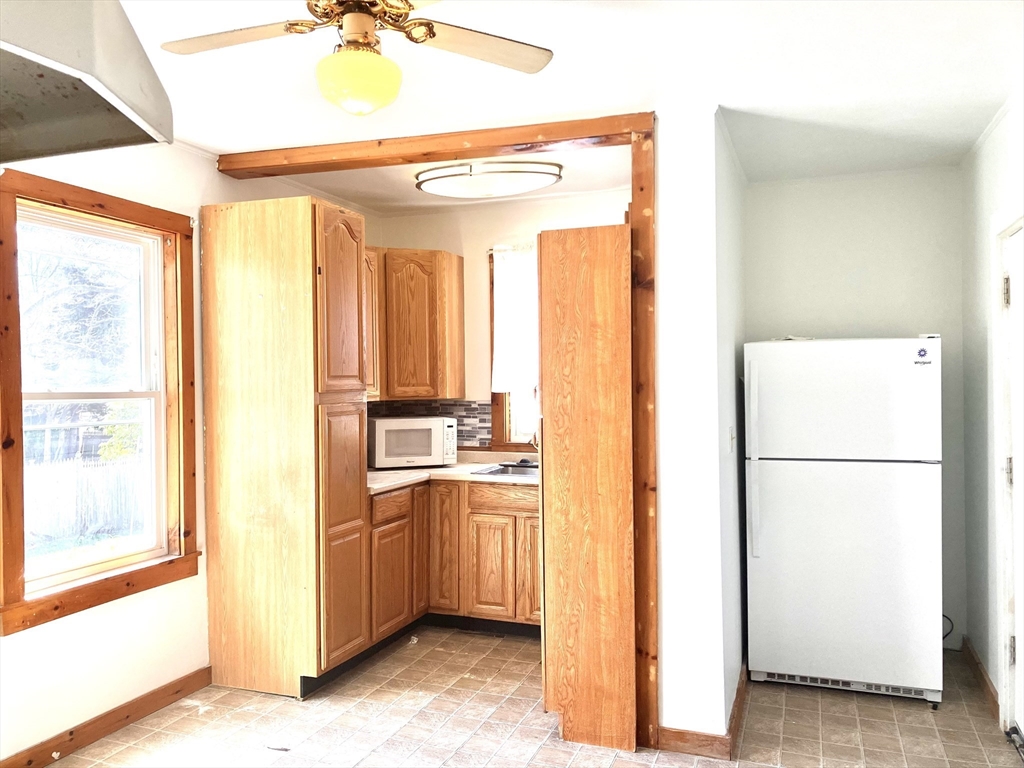4 Sisson Terrace, Unit 1 Lynn, MA 01902 - Photo 6 of 16 a kitchen with a refrigerator a sink and a window