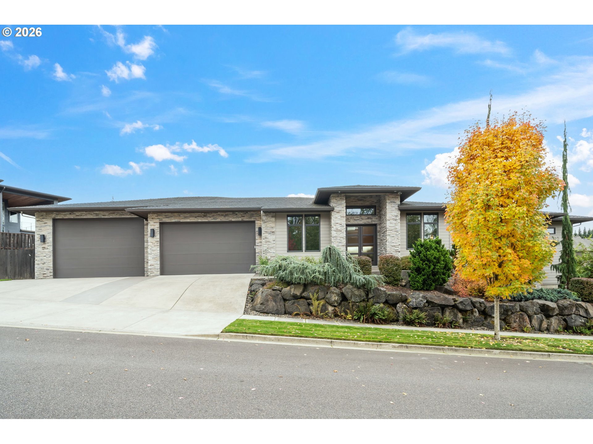 a front view of a house with a yard and garage