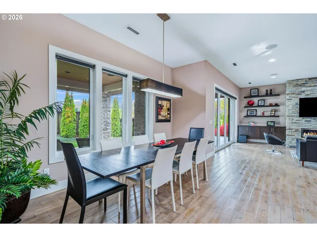 a dining room with furniture and wooden floor