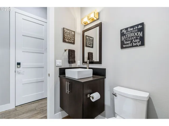 a bathroom with a sink a toilet and mirror