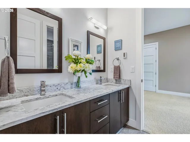 a bathroom with a granite countertop sink a large mirror and a