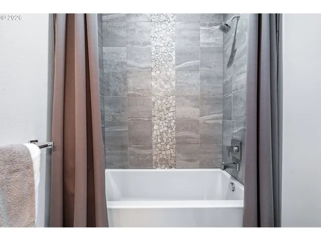 a bathroom with a bathtub and a shower