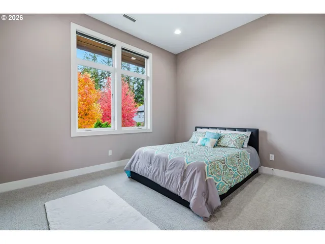 a bed sitting in a bedroom next to a window