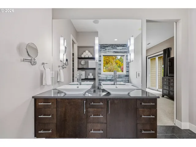 a bathroom with a granite countertop sink a large mirror and a window