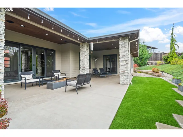 a view of a house with patio and a yard