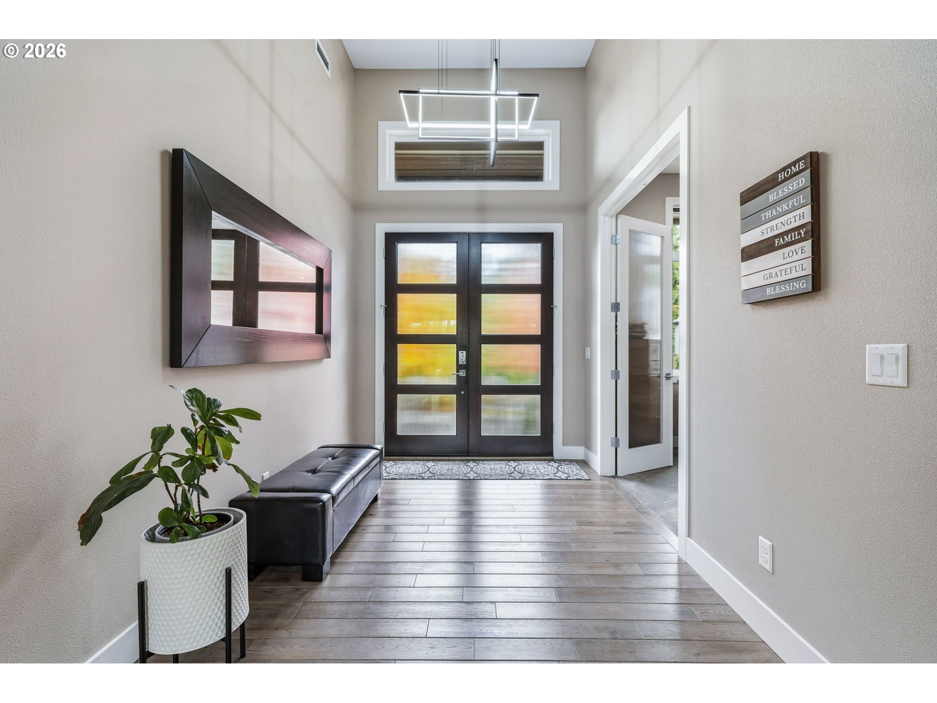 1203 South Great Blue Road Ridgefield, WA 98642 - Photo 4 of 48 a view of a hallway with wooden floor and a potted plant