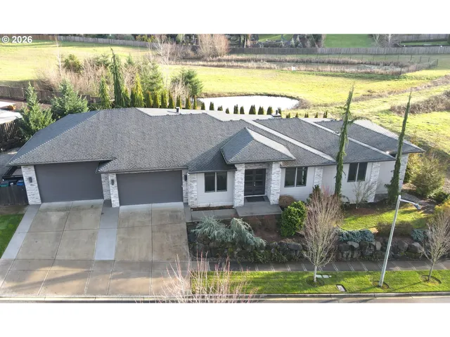 a house view with a garden and pool