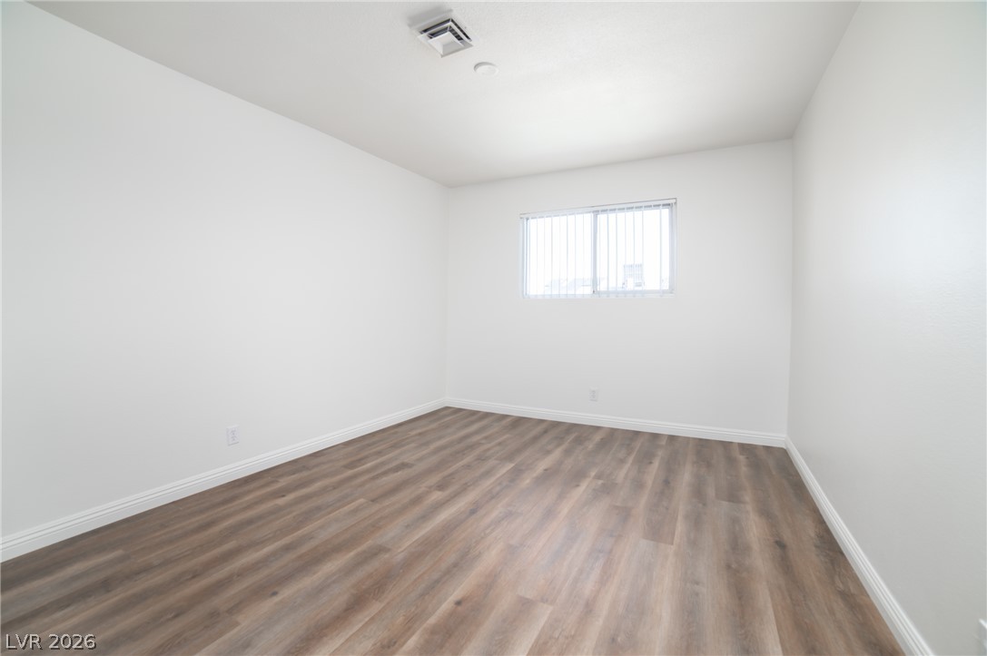 3556 Ruth Drive Las Vegas, NV 89121 - Photo 14 of 21 A well-proportioned room with light-toned laminate flooring and a window offering natural illumination.