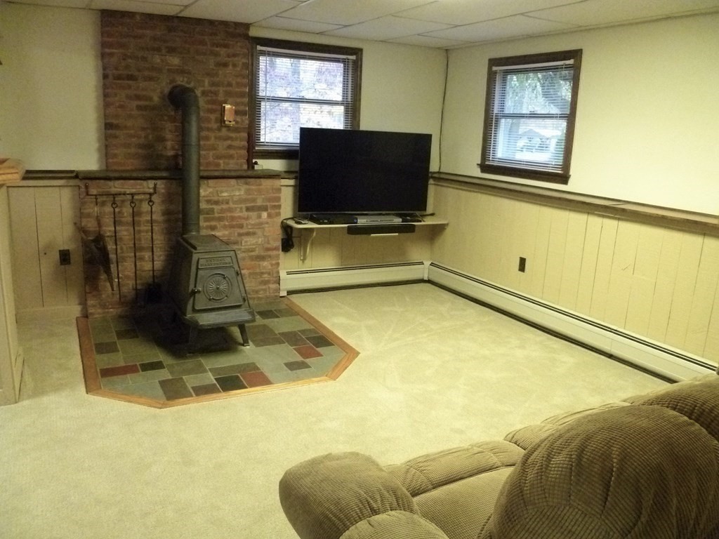 1209 Amostown Road West Springfield, MA 01089 - Photo 17 of 29 a living room with a flat screen tv and floor to ceiling window
