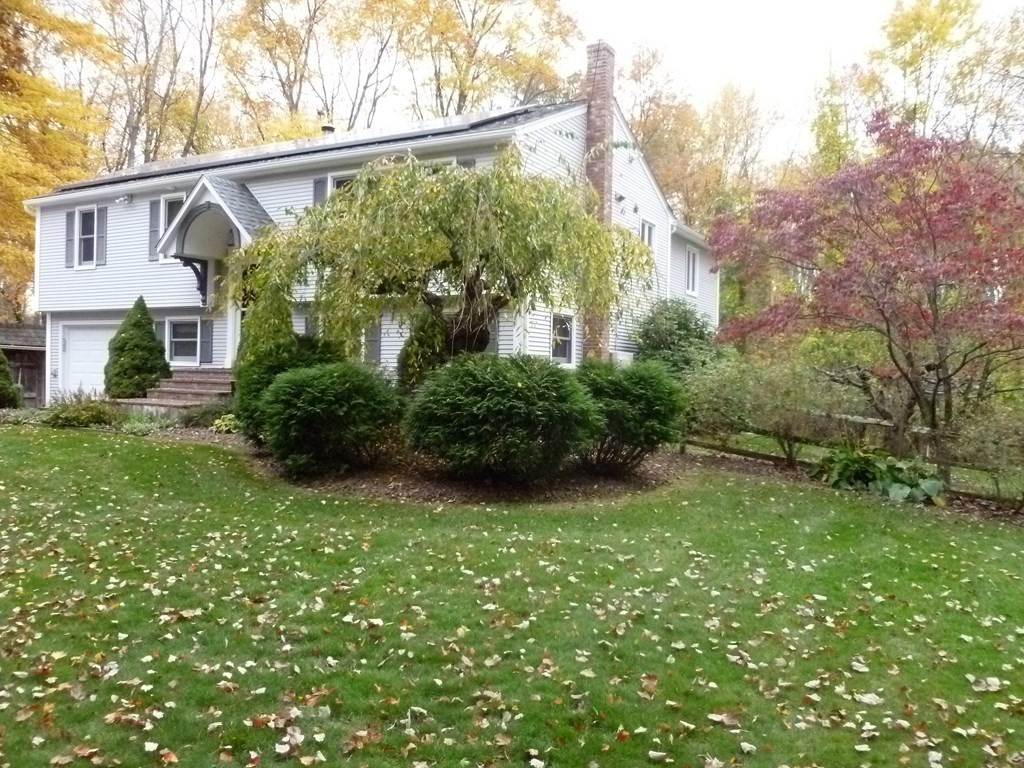 1209 Amostown Road West Springfield, MA 01089 - Photo 2 of 29 a view of a white house next to a yard with big trees