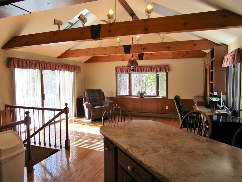 1209 Amostown Road West Springfield, MA 01089 - Photo 5 of 29 a dining hall with couches a dining table and chairs with wooden floor