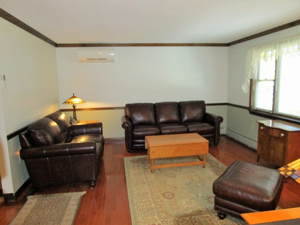 1209 Amostown Road West Springfield, MA 01089 - Photo 8 of 29 a living room with furniture and a flat screen tv