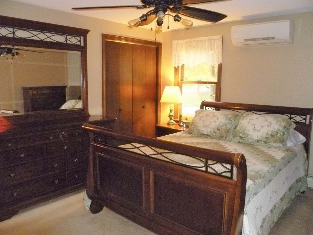 1209 Amostown Road West Springfield, MA 01089 - Photo 10 of 29 a bedroom with a bed and a dresser