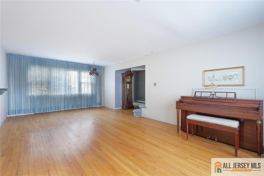 9 Woodruff Road Edison, NJ 08820 - Photo 8 of 39 a view of a room with wooden floor and windows