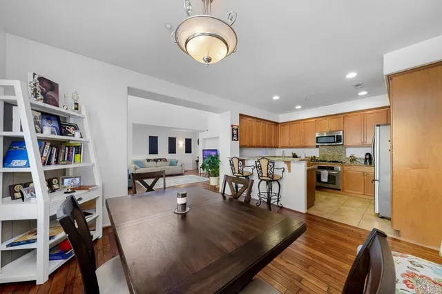 a view of a dining room and livingroom with furniture wooden floor and a rug