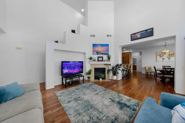 a living room with furniture a fireplace and a flat screen tv