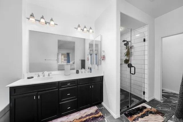 a bathroom with a double vanity sink and mirror