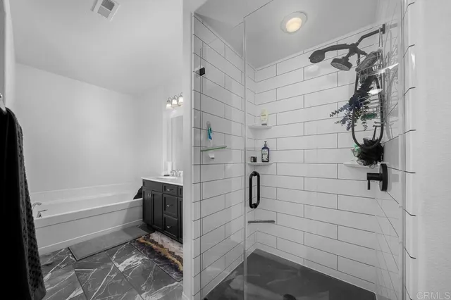 a bathroom with a bathtub and shower