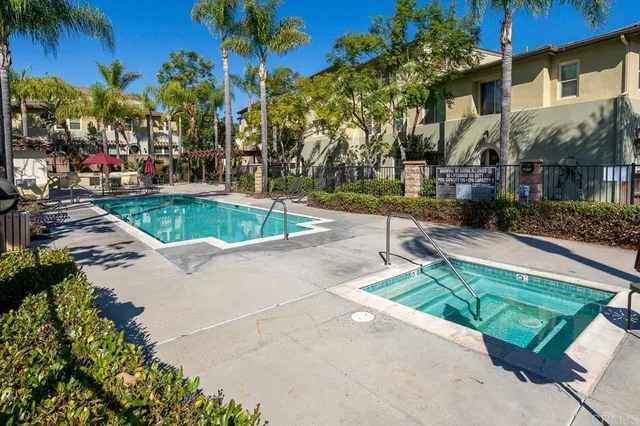 a view of backyard with swimming pool and outdoor seating