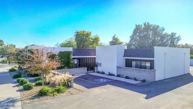 a backyard of a house with table and chairs