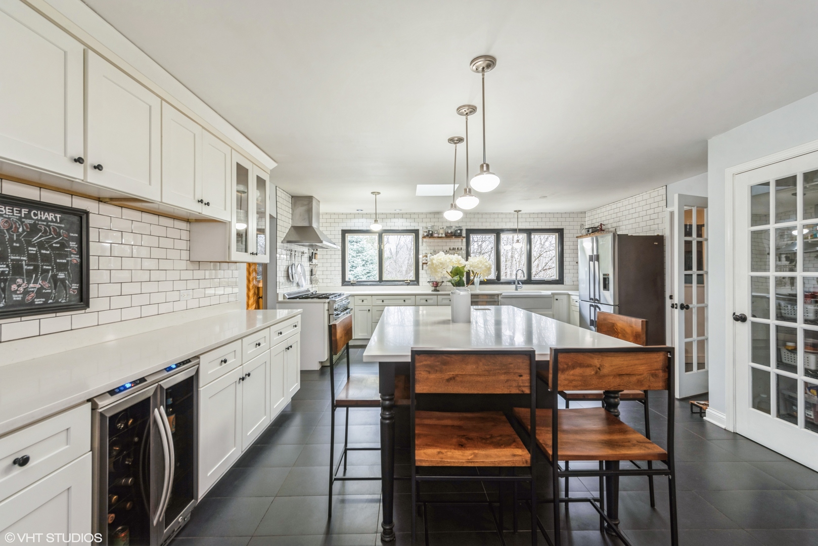 6208 Katmai Trail McHenry, IL 60050 - Photo 5 of 24 a kitchen with stainless steel appliances kitchen island granite countertop a table chairs and a refrigerator