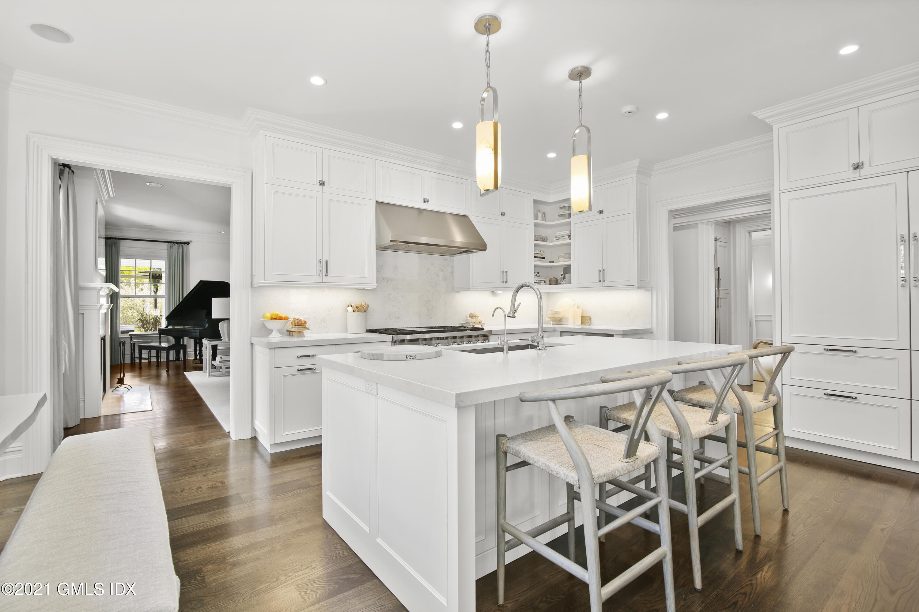16 Benjamin Street Old Greenwich, CT 06870 - Photo 11 of 32 a kitchen with kitchen island a stove a table a sink refrigerator and cabinets