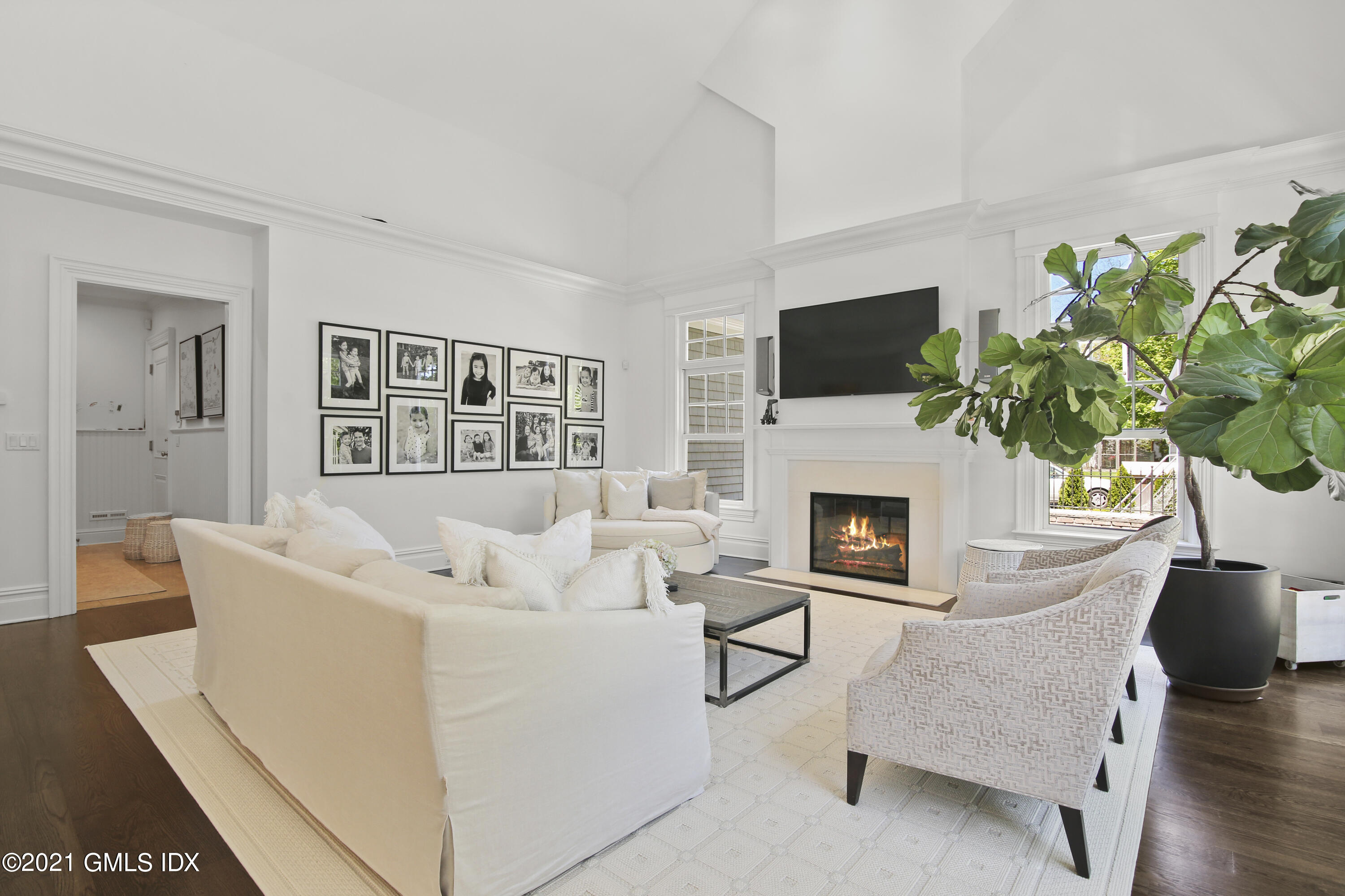 16 Benjamin Street Old Greenwich, CT 06870 - Photo 13 of 32 a living room with furniture a flat screen tv and a fireplace