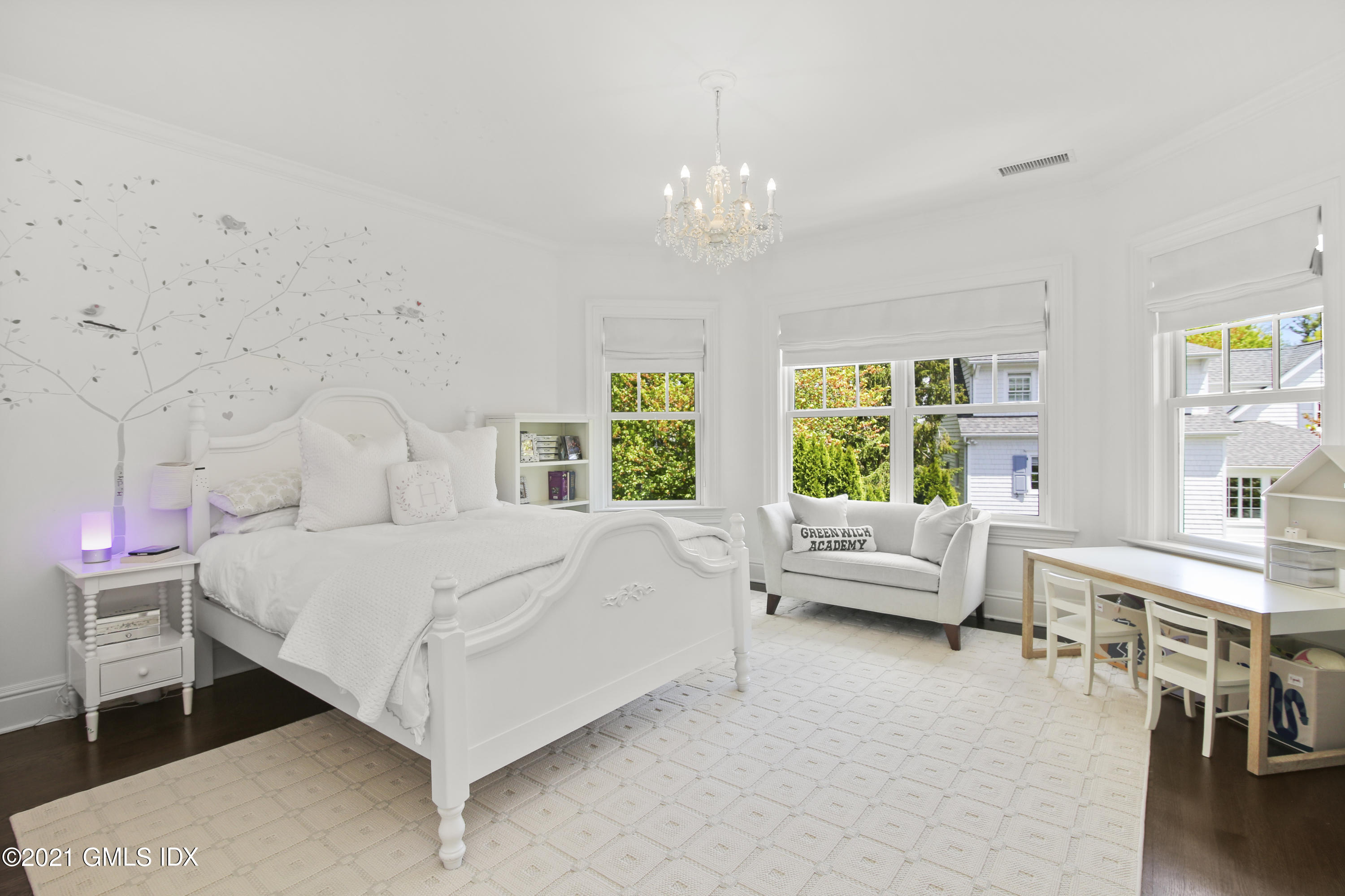 16 Benjamin Street Old Greenwich, CT 06870 - Photo 20 of 32 a bed room with a bed and a chandelier