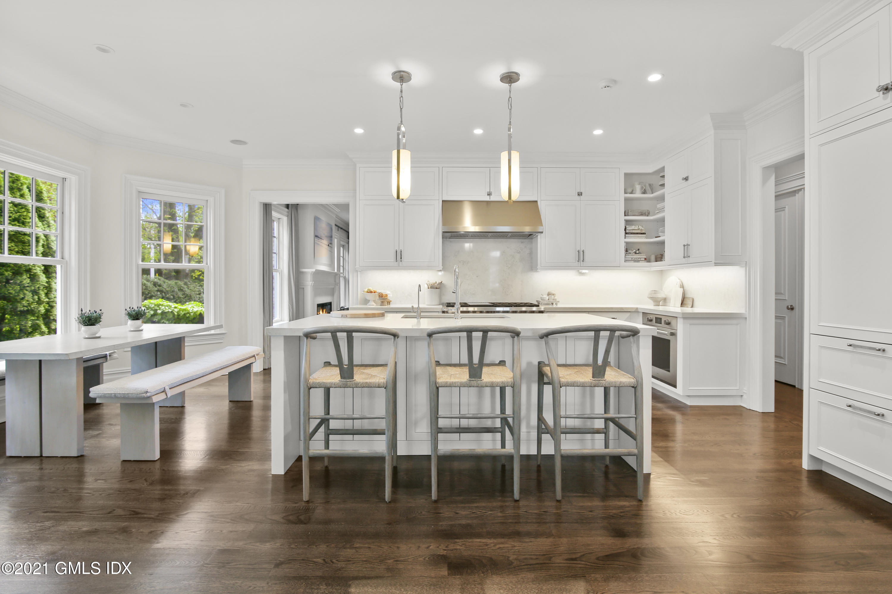 16 Benjamin Street Old Greenwich, CT 06870 - Photo 8 of 32 a kitchen with stainless steel appliances granite countertop a stove a refrigerator a kitchen island a dining table and chairs with wooden floor