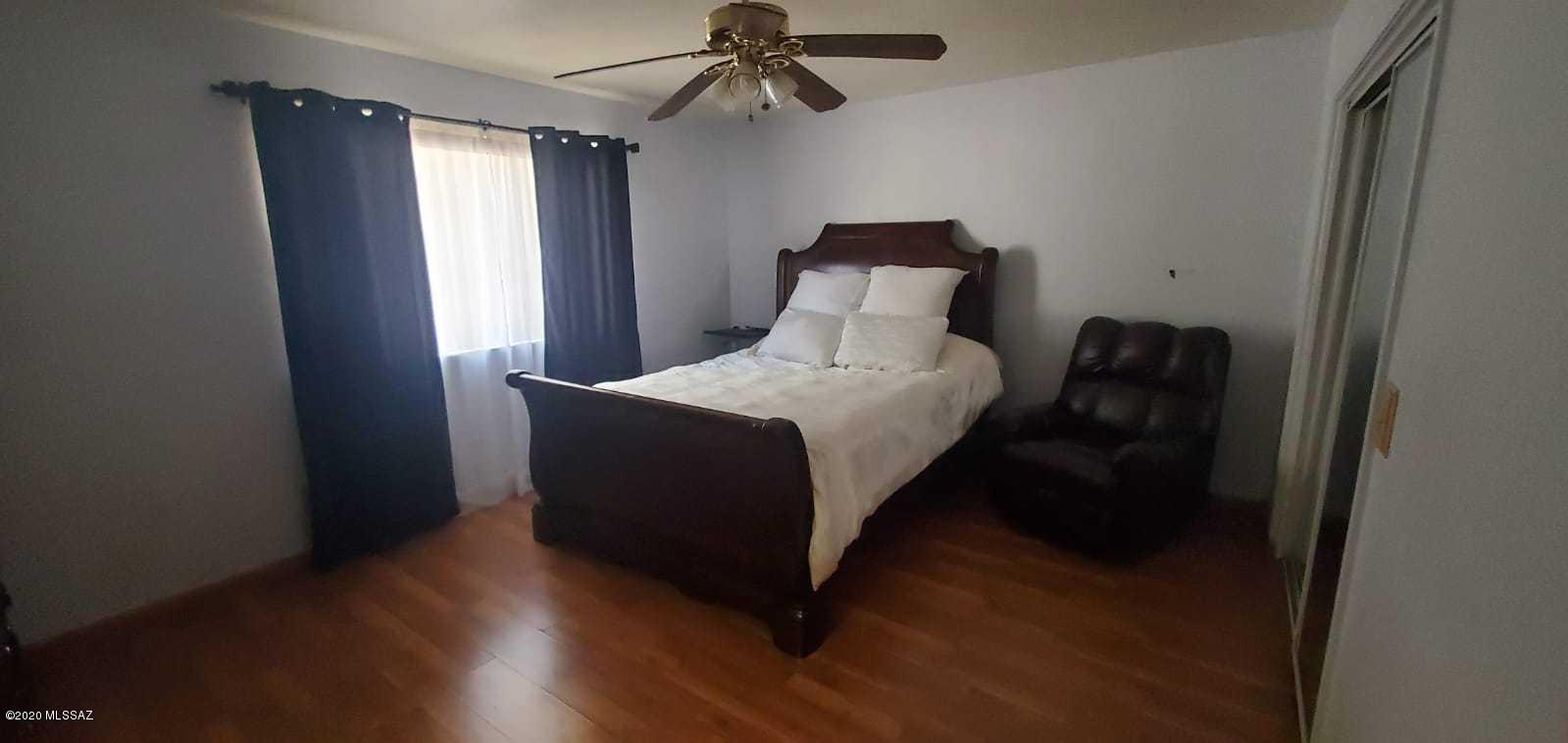 173 Nabo Court Rio Rico, AZ 85648 - Photo 18 of 26 a bedroom with a bed and window