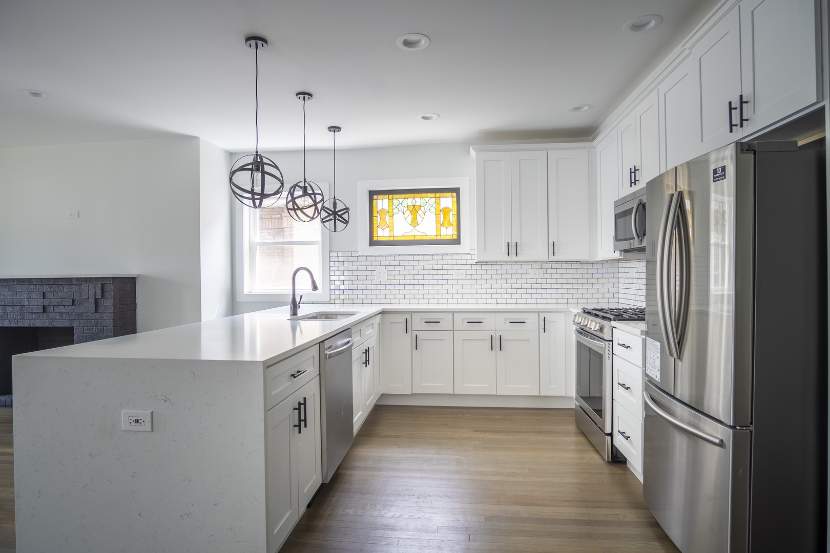 1055 North Drake Avenue Chicago, IL 60651 - Photo 1 of 1 a kitchen with stainless steel appliances granite countertop a refrigerator a sink dishwasher a stove and white countertops with wooden floor