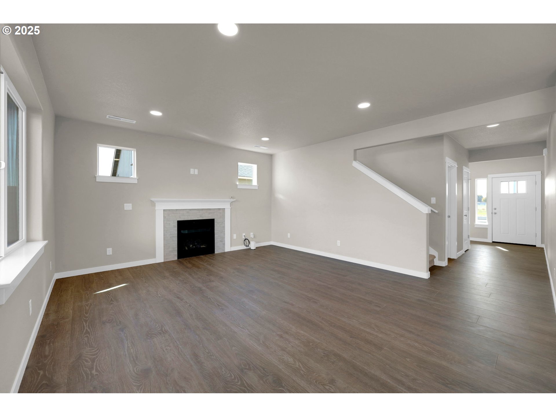 5679 Magnificence Way Eugene, OR 97402 - Photo 12 of 45 a view of an empty room with wooden floor and a fireplace