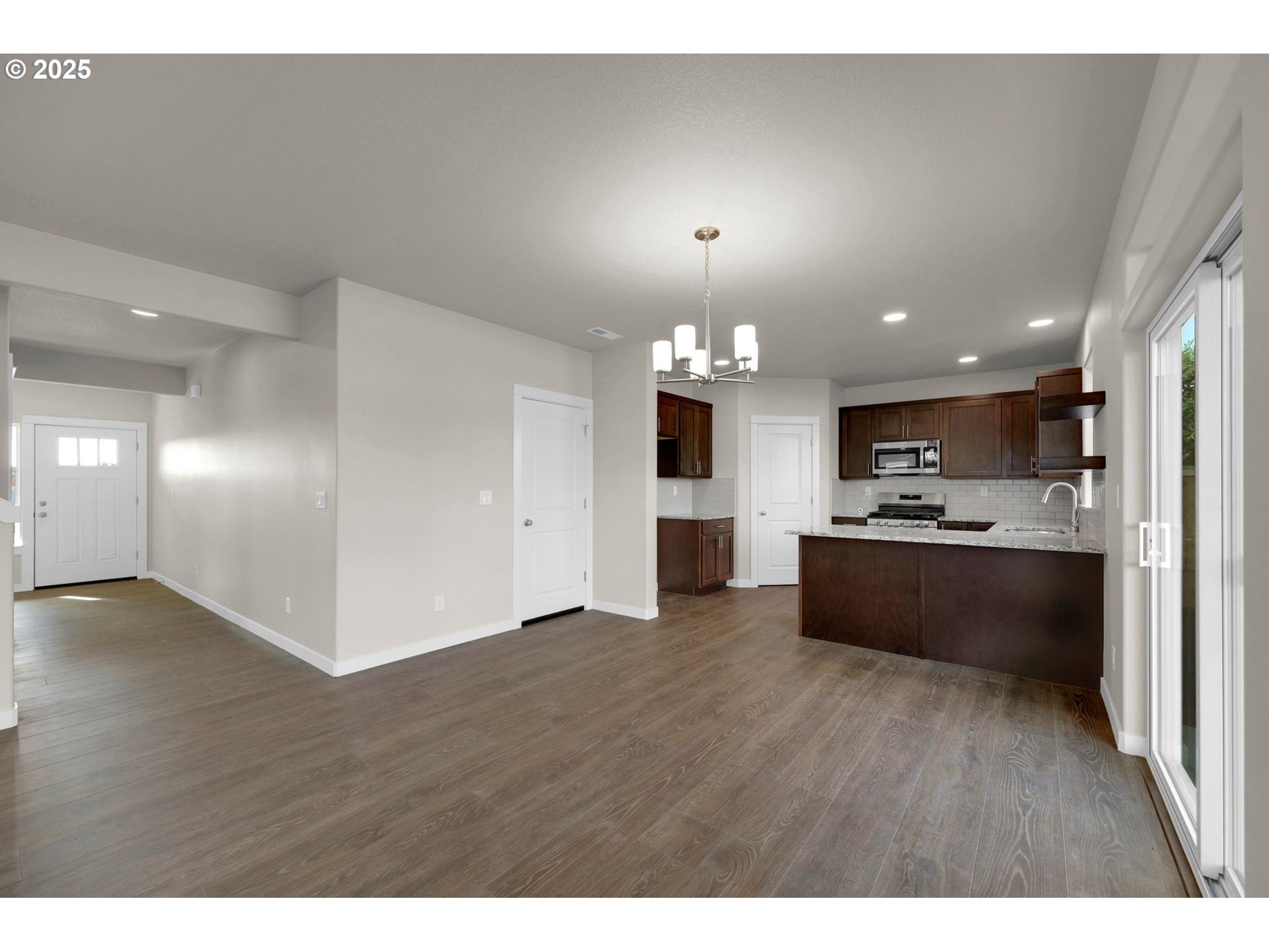 5679 Magnificence Way Eugene, OR 97402 - Photo 14 of 45 a view of large kitchen with refrigerator and wooden floor