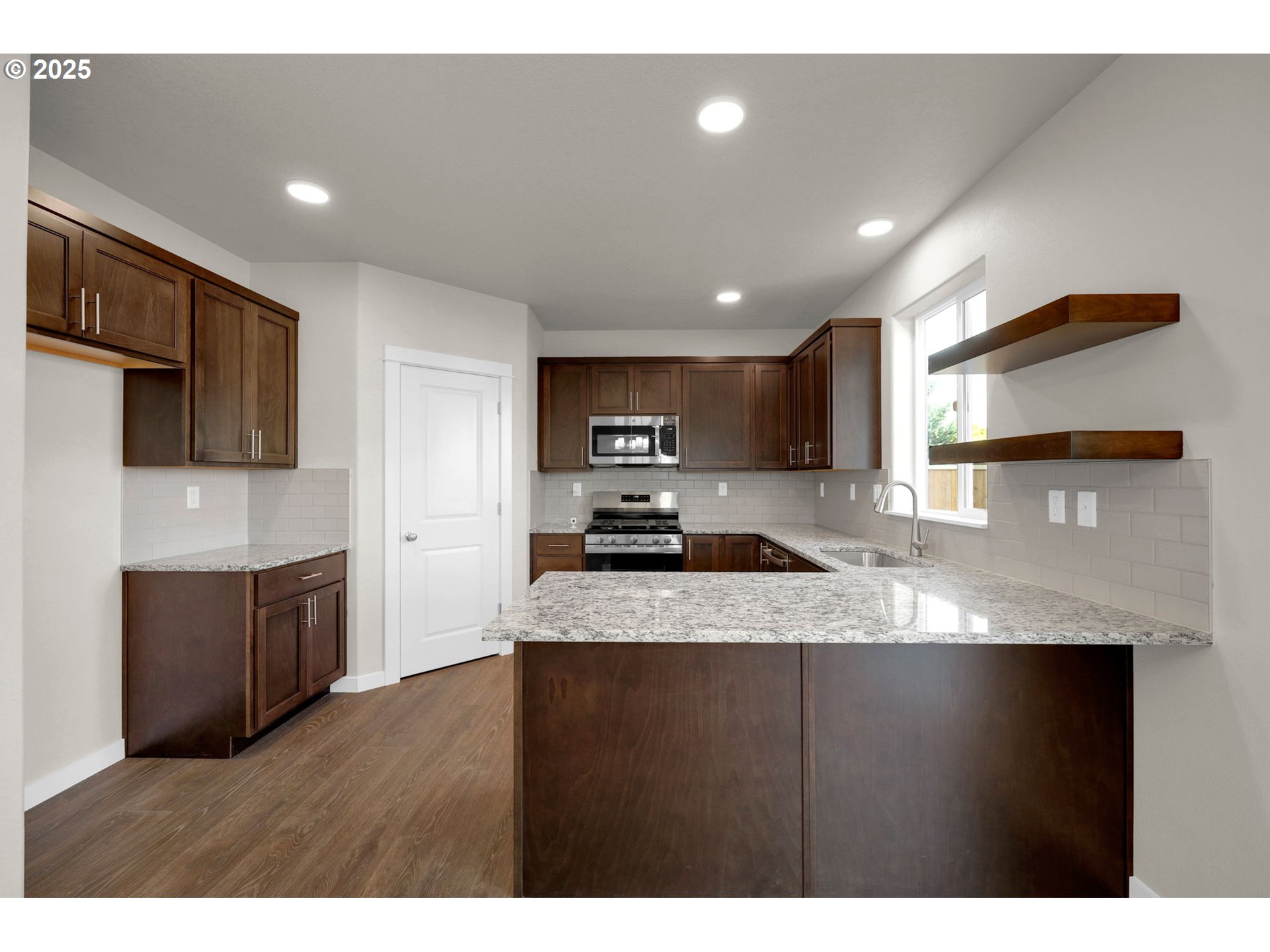 5679 Magnificence Way Eugene, OR 97402 - Photo 17 of 45 a kitchen with a sink a stove and cabinets