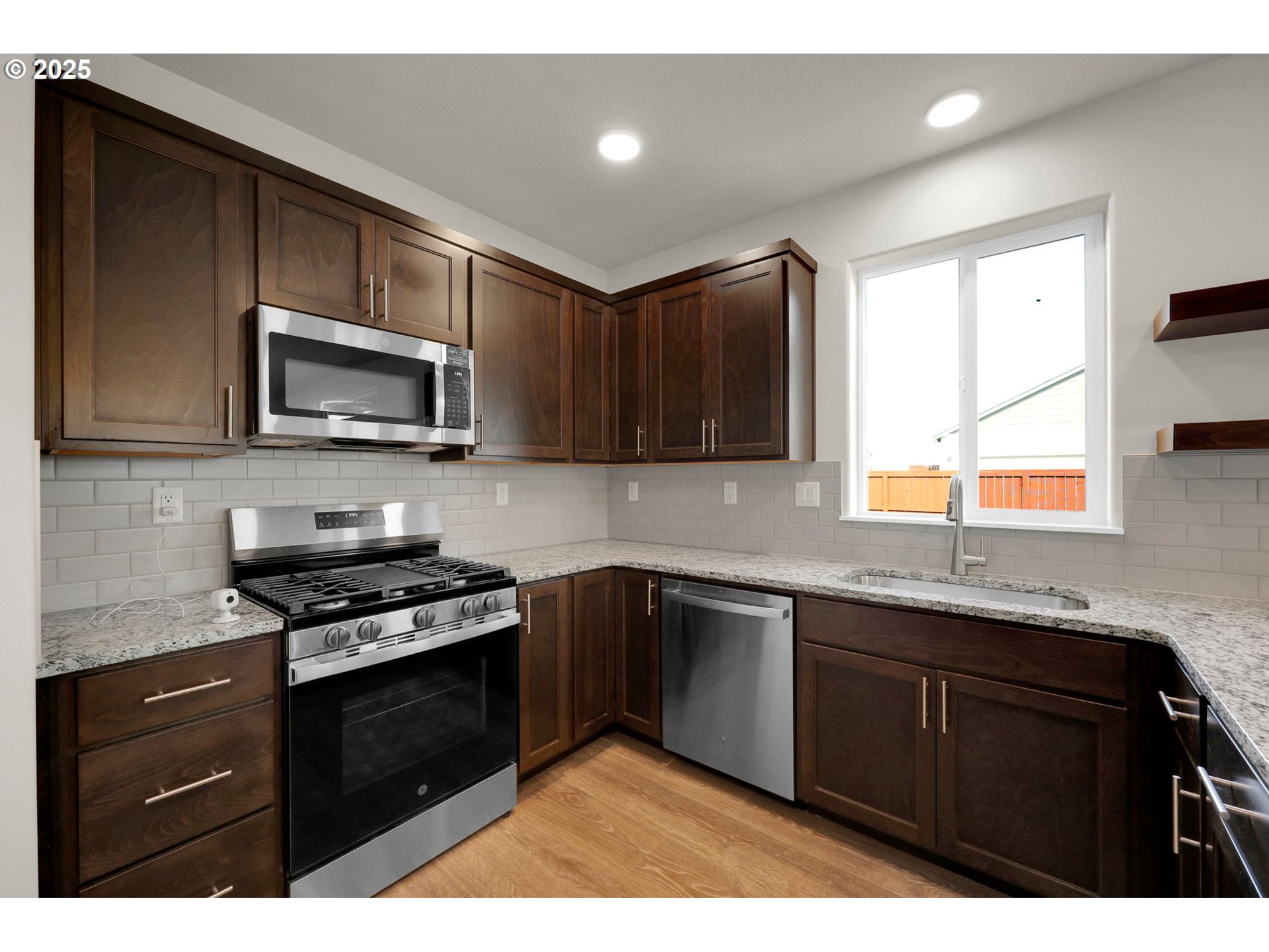 5679 Magnificence Way Eugene, OR 97402 - Photo 21 of 45 a kitchen with granite countertop a sink cabinets and stainless steel appliances