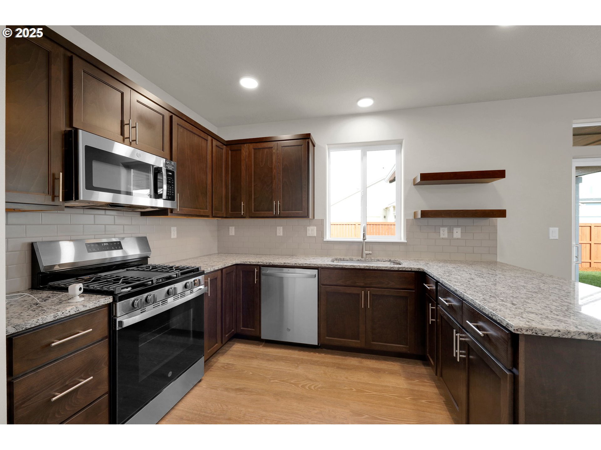 5679 Magnificence Way Eugene, OR 97402 - Photo 22 of 45 a kitchen with stainless steel appliances granite countertop wooden cabinets a stove a sink and a granite counter tops