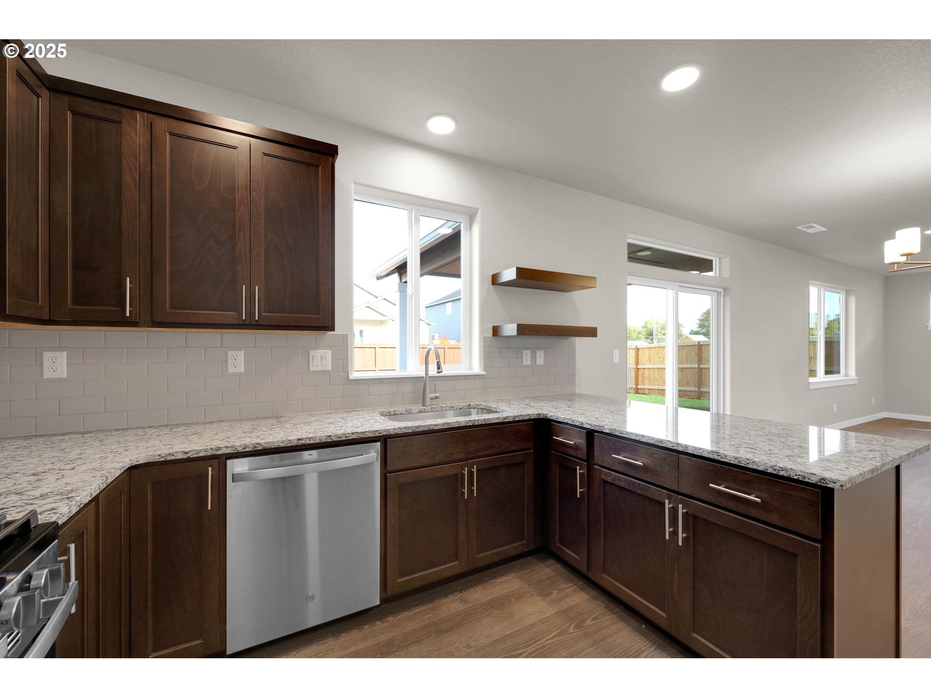 5679 Magnificence Way Eugene, OR 97402 - Photo 23 of 45 a kitchen with granite countertop a sink and cabinets